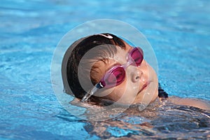 Child learning to swim, swimming lesson