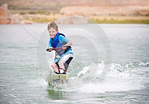 Child learning to wakeboard