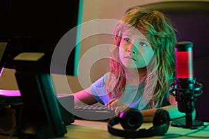 Child learning in virtual online school class. Kid working on laptop Internet at home. Child using laptop computer
