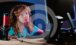 Child learning in virtual online school class. Kid working on laptop Internet at home. Child using laptop computer