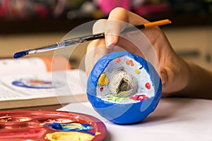 Child learns biology, studies the structure of the cell. Cell is made of clay and painted with tempera