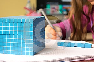 Child learns math, volume and capacity. For learning model uses a three-dimensional cube.