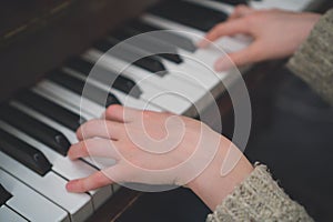 Child learns the piano.