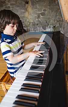 A child learns to play the piano