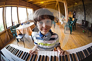 A child learns to play the piano