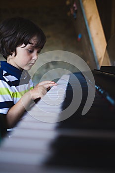 A child learns to play the piano