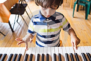 A child learns to play the piano