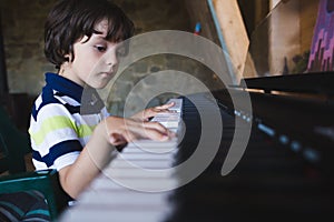 A child learns to play the piano