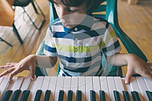 A child learns to play the piano