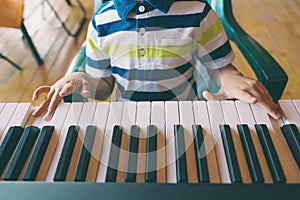 A child learns to play the piano