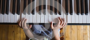 A child learns to play the piano