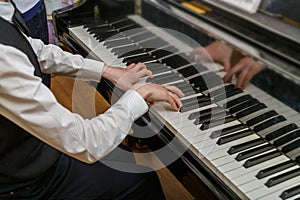 A child learns to play the piano in a music studio.
