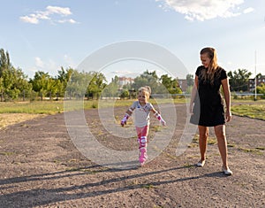 Child learns to roller skate. Roller skating