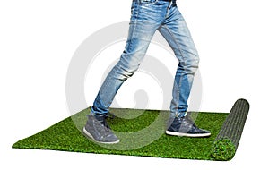 Child legs walking on artificial grass isolated on white