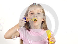 Child lets the soap bubbles. White background