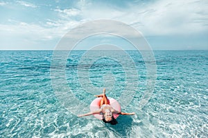 Child on lilo relaxing on the beach