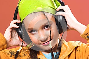 Child listening music in headphones