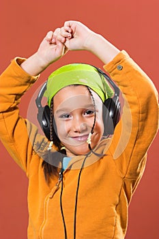 Child listening music in headphones