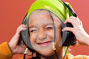 Child listening music in headphones