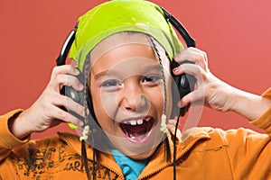 Child listening music in headphones