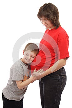 Child listening to her pregnant mother's belly