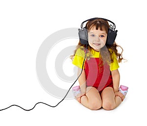 Child listens attentively to music on white