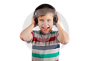 Child listens to his favorite music on headphones and dances to it , isolated on white background. Leisure, music and