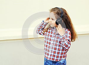 Child listens to music in headphones