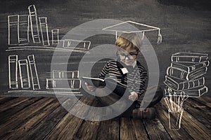 Child Little Boy in Glasses Reading Book over School Black Board