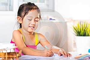 Child little girl drawing cartoon on paper before paint the color