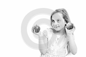 Child or little girl eating apple isolated on white background