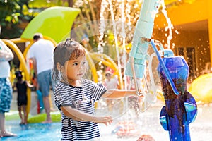 Child little girl having fun to play with water