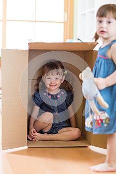 Child little girl inside box