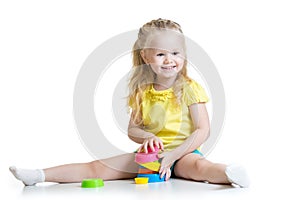 Child little girl playing with color toys