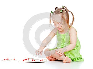 Child little girl playing with developmental toy photo