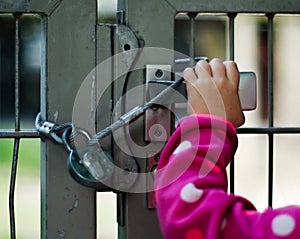 Child locked up behind a fence