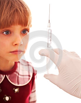 Child look at hand with syringe.