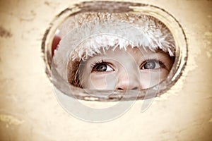 Child look out of hole