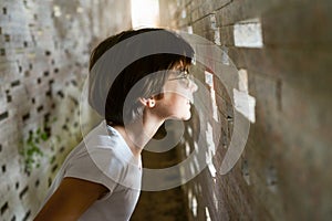 Child looking through the bricks inside the Nazari Wall photo