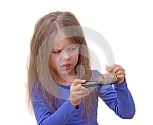 Child looking at brush with piece of hair with disgust