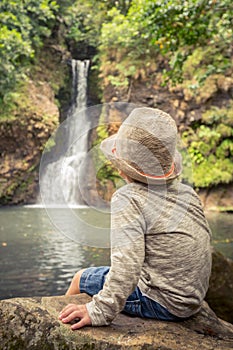 Child looking Chamouze waterfall. Mauritius