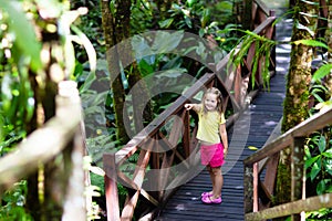 Child looking at flower in jungle