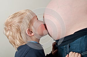 Child looking at mothers pregnancy bump