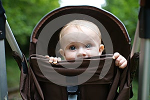 Child looking out of carriage. Travelling with Kids. Transportation for children
