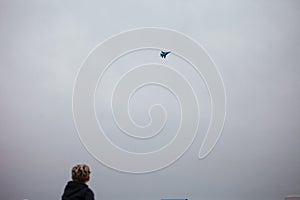 Child is looking on the Russian fighter bomber Sukhoy Su-34 during a demonstration flight