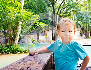 Child looking waterfall. Laos