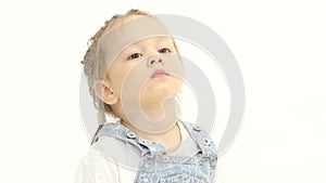 Child looks around trying to find his mother. White background