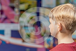 A child looks at paintings in an art gallery in the fine arts exhibition hall