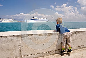 Child looks on the ship