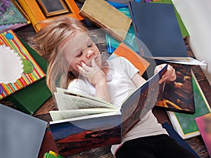 Child and a lot of books around. photo